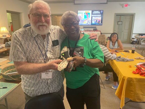 Two people with The Pan African Sisterhood Health Initiative.