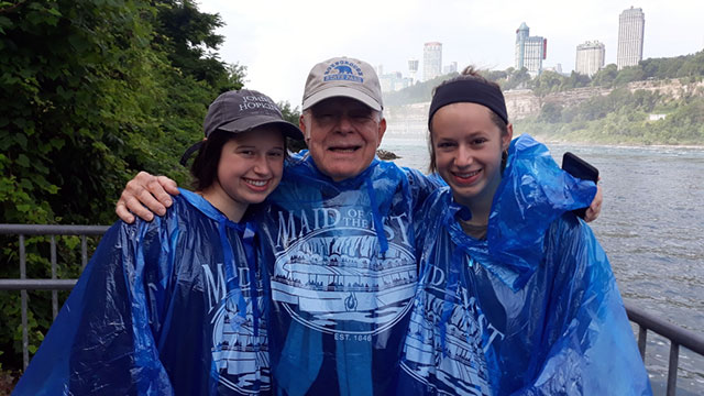 Co-clerk, George Salloom with his granddaughters in blue rain ponchos