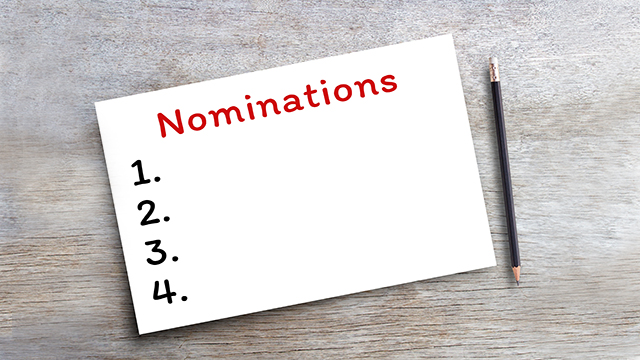 Handwriting text writing Nominations on blank white paper on wood table.Concept meaning action of nominating