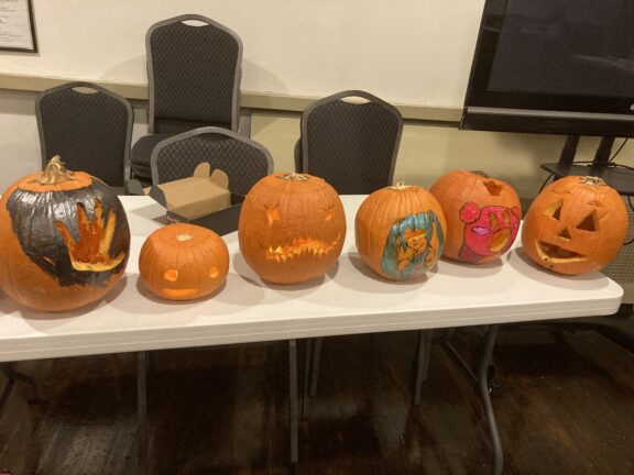 A display of freshly carved pumpkins by Young and Middle School Friends